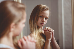 young girl considering the benefits of eating disorder treatment centers for teens